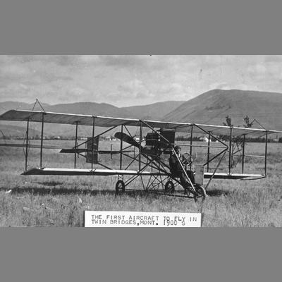 Dual Winged Aircraft in Grassy Field with Pilot at the Controls, Twin Bridges, Montana, ca. 1900s