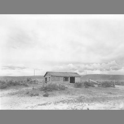 Abandoned Log Cabin in a Sagebrush Covered Field