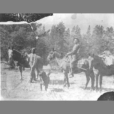 Billy Vipond and Sturm - Two men pose with two saddled horses.