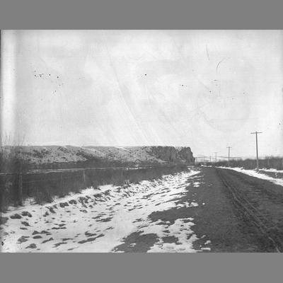 Snowy road next to telephone poles in Twin Bridges, Montana, 1896.
