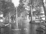 Two men observe the flood near the fairgrounds in Twin Bridges, Montana, 1896.