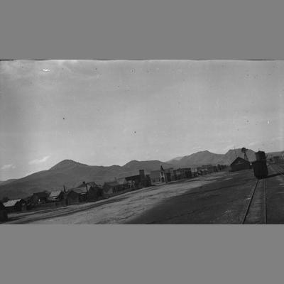 Railroad tracks placed on the edge of a small town.