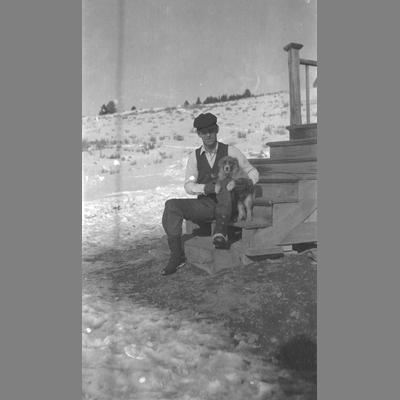 Man Poses with Dog on Steps of Porch