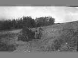 Two Pioneer Women Firing a Gun in a Field