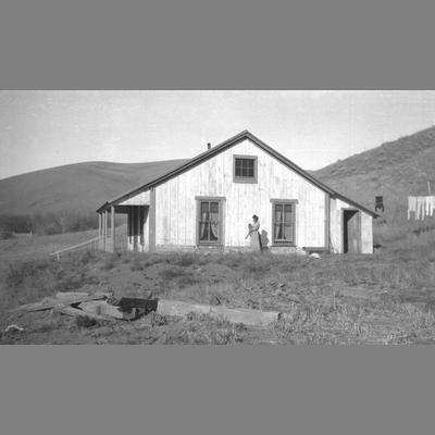 Woman Holding Cat Outside Country Home