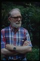 Ivan Doig wearing plaid shirt with arms crossed - darker exposure