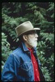 Ivan Doig standing profile in denim jacket and red shirt