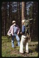 Ivan Doig and Bud Moore stand together in a forest 2
