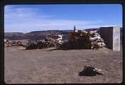 Acoma Pueblo, New Mexico - dog lying down in front of log stacks