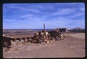 Acoma Pueblo, New Mexico - a pile of wood next to mesa edge