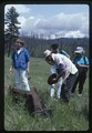 Jerry DeSanto, Linda Bierds, and Sydney Kaplan study rusty machinery along the trail in Glacier National Park