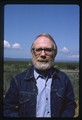 Ivan Doig smiling in denim jacket and blue shirt