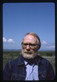 Ivan Doig in a denim jacket and blue shirt looking into the distance