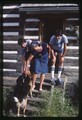 Annick, Alec, and Andrew Smith on the porch of their cabin