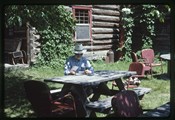Polebridge, Montana - Ivan Doig looking at photographs of 1988 fire