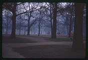Horsemen ride along dirt path in Hyde Park, London