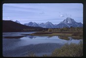 Grand Tetons mountain range behind Snake River in Wyoming (left)