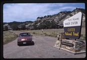 Ivan Doig sitting at the Fort Howes ranger station entrance