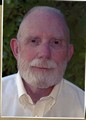 Ivan Doig with green leaves in the background