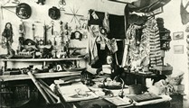 James G. Swan sitting in room of Makah Tribe artifacts
