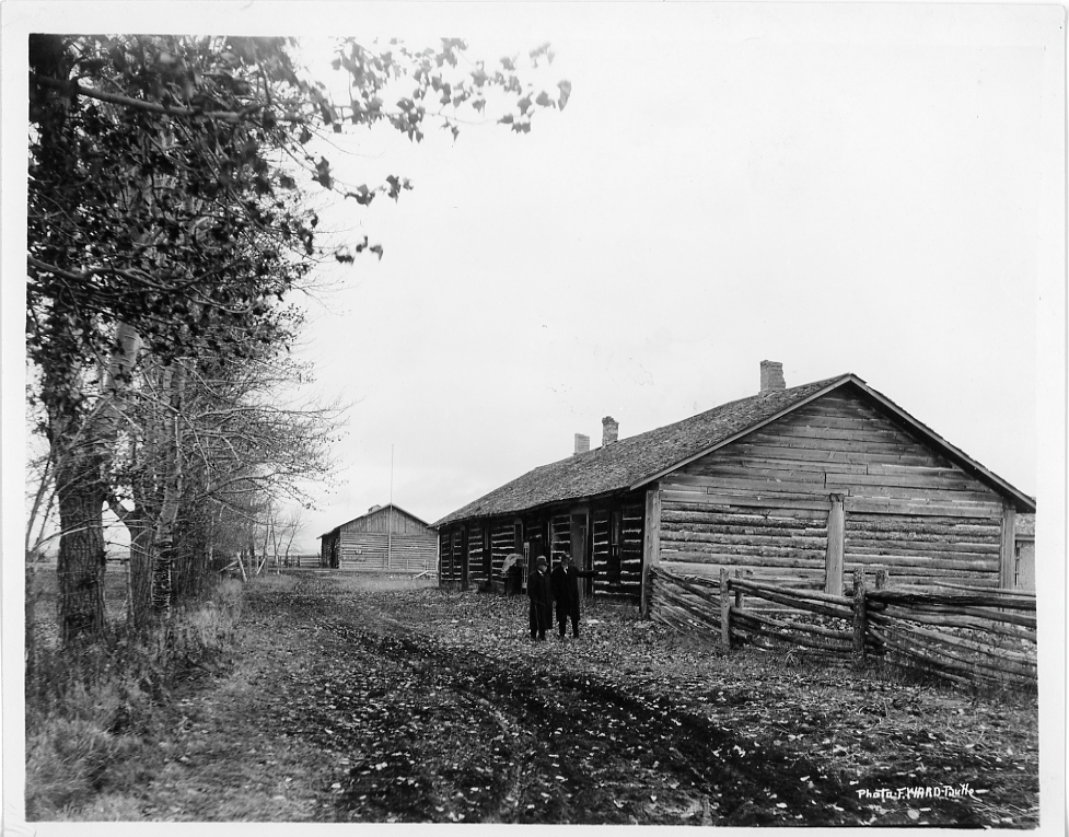 Two unidentified men inspecting ruins of Fort Logan (Camp Baker)