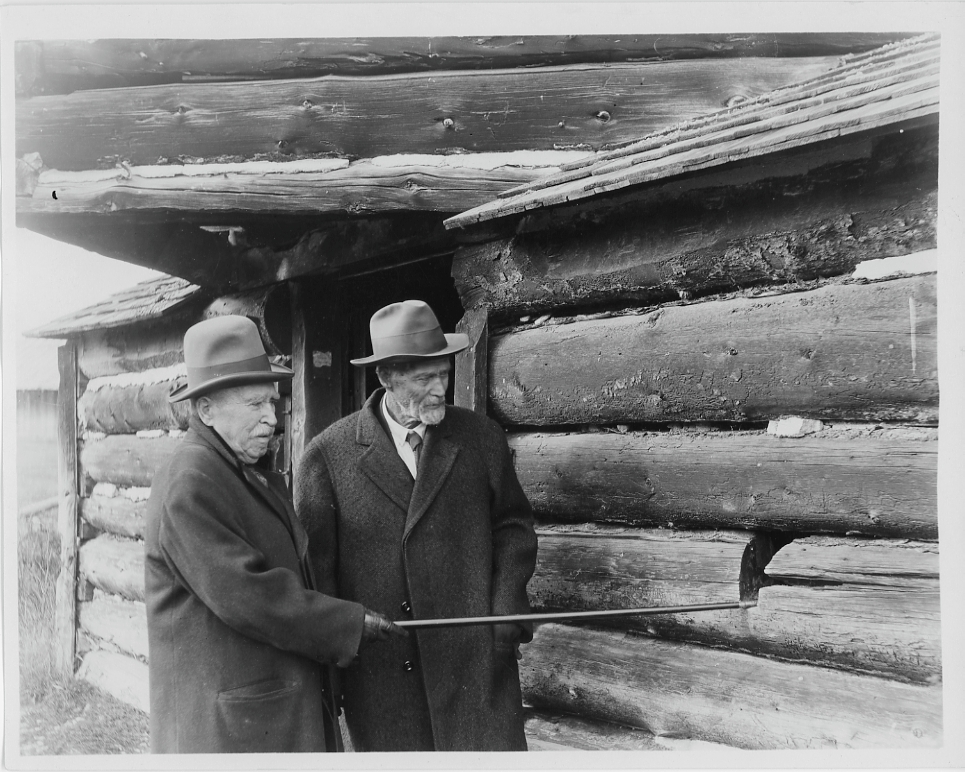 Two men inspecting the Fort Logan (Camp Baker) ruins