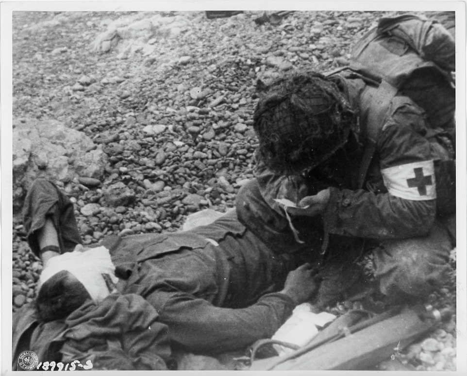 American medic making a casualty report on a wounded soldier
