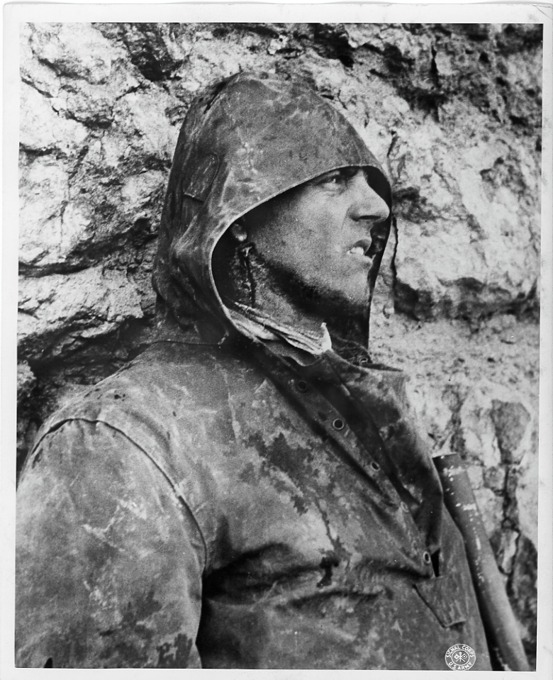 American soldier standing against a chalk cliff