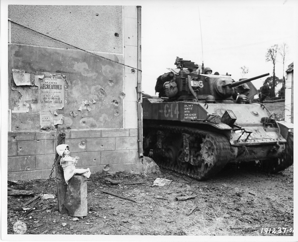 American tank in France with a French girl's doll in the foreground