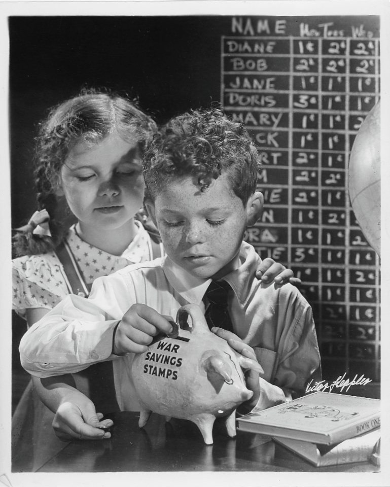 Children in promotional campaign pictures placing money in a War Savings Stamps piggybank