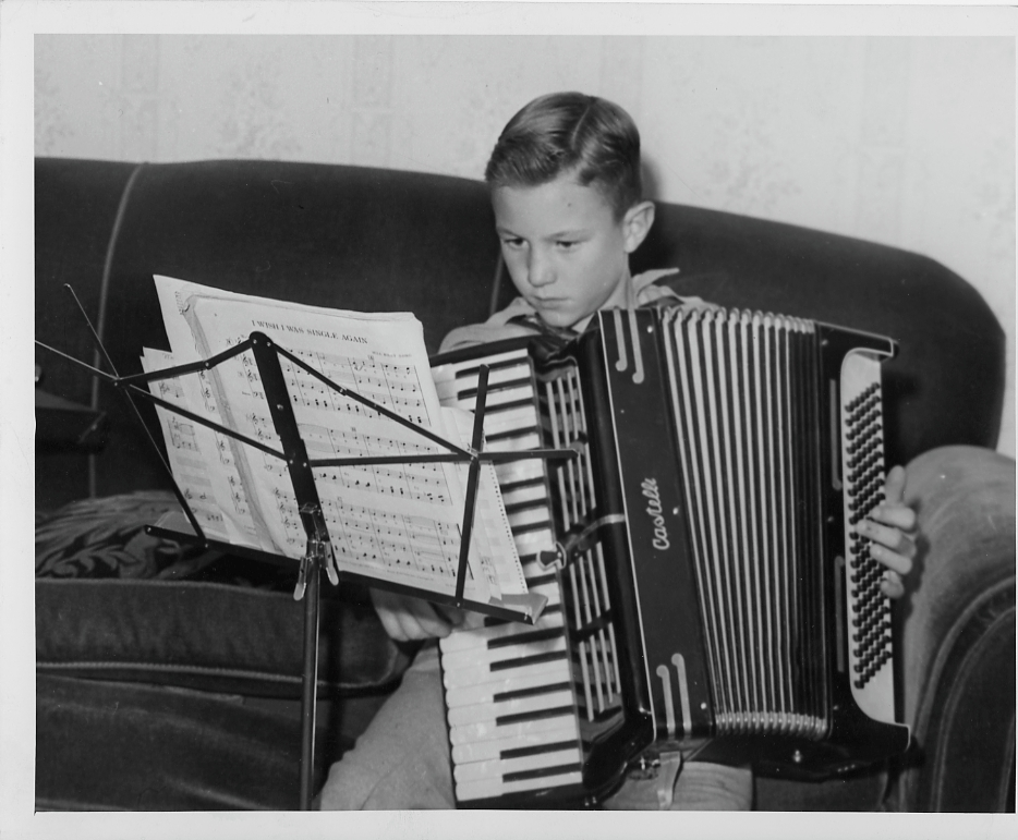 Young boy playing an accordion