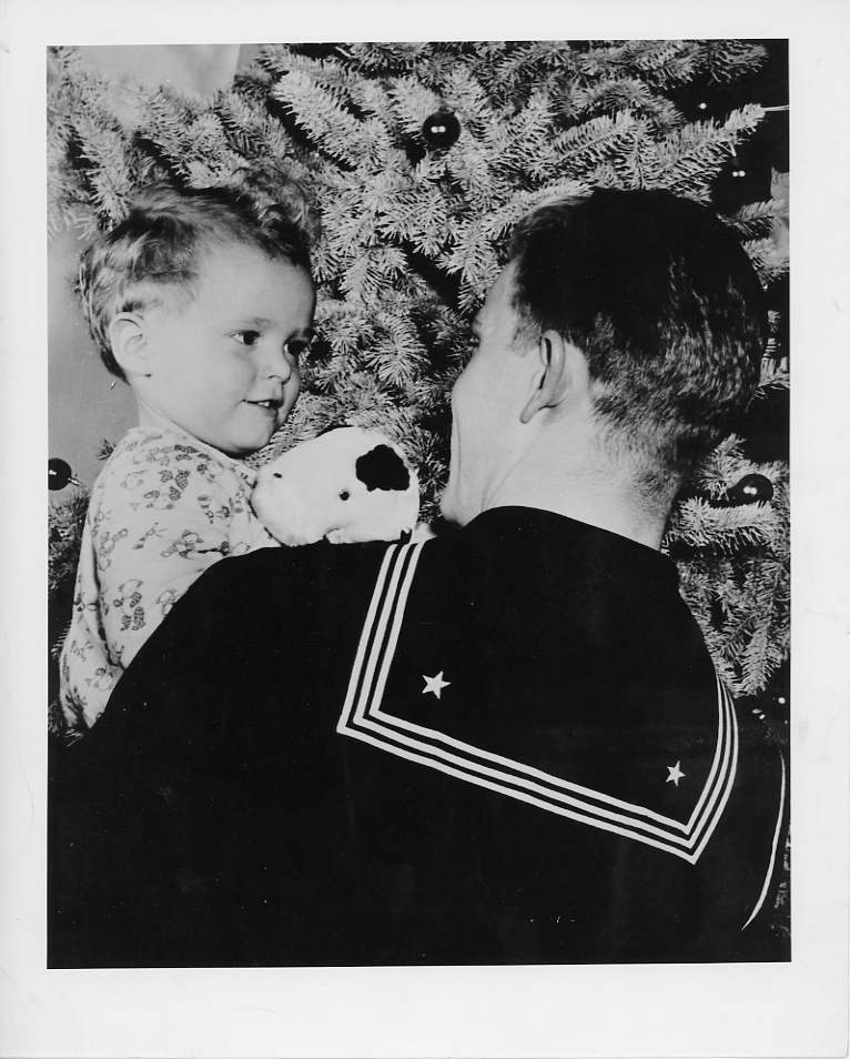 Christmas photo of Coast Guard man with a child