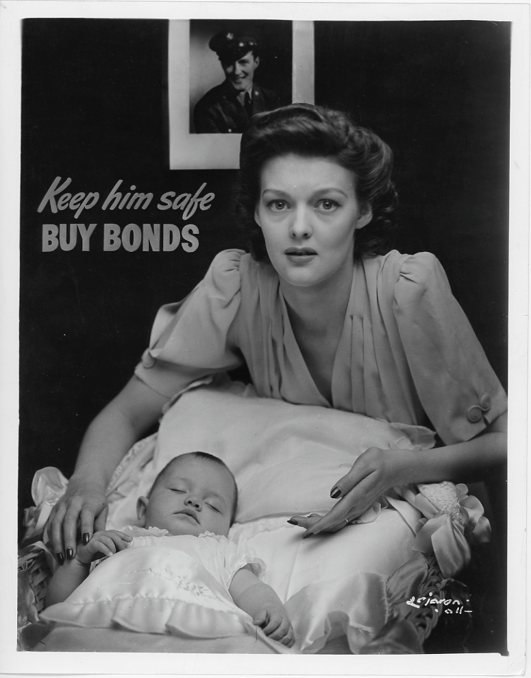Promotional photo of a mother and a sleeping baby with the slogan \"Keep him safe, Buy Bonds\"