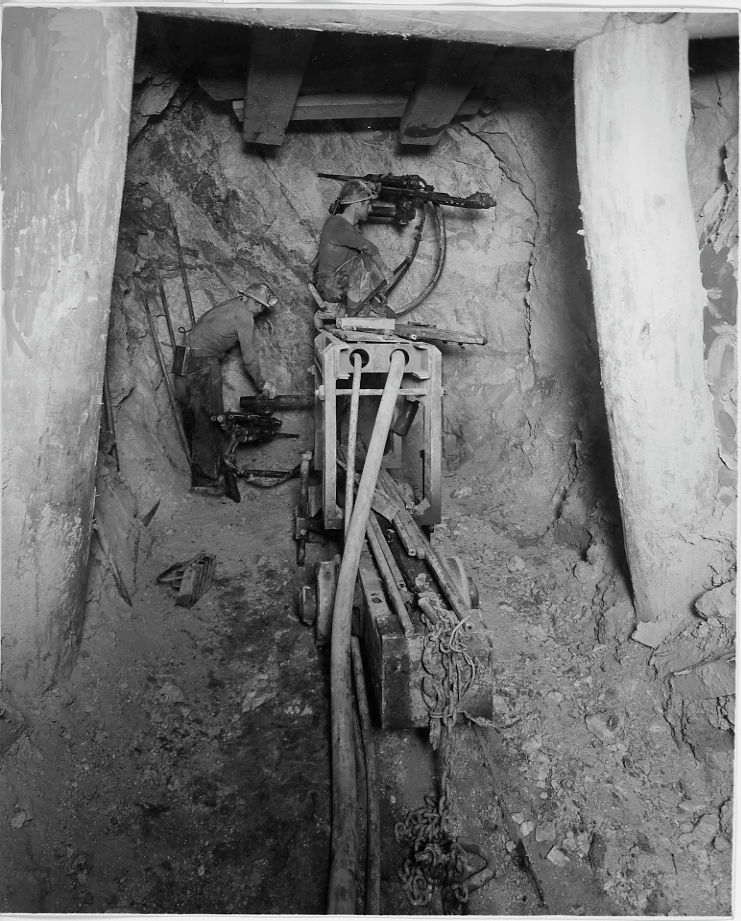 Two miners with drilling machinery