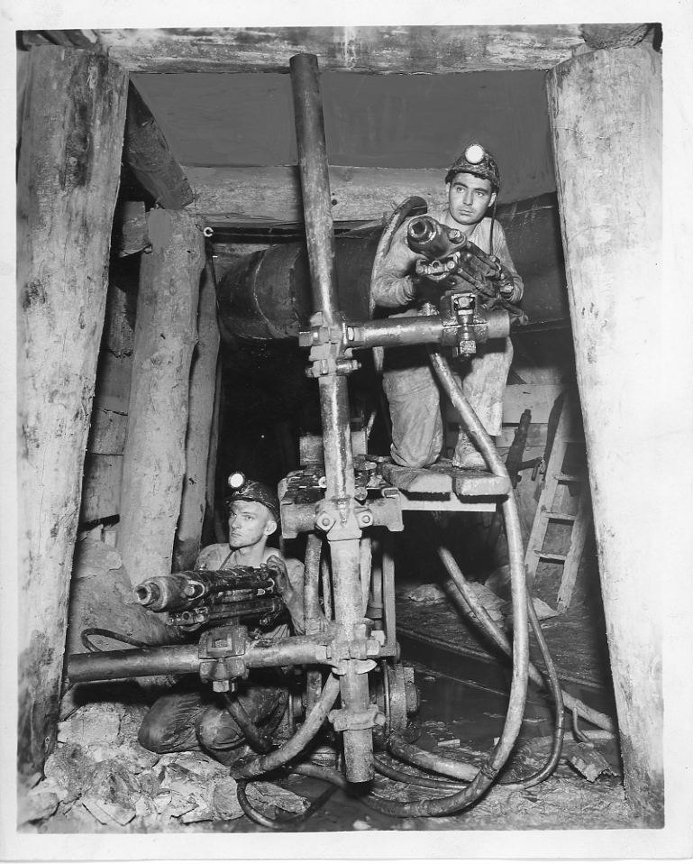 Two miners with drilling machinery