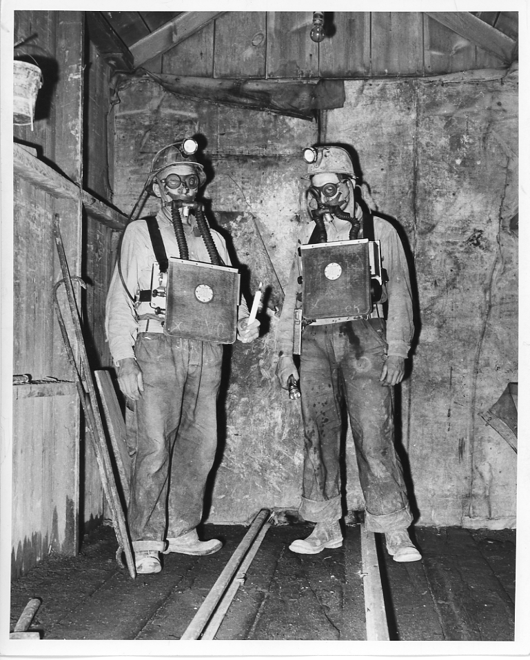 Two Butte miners showing safety equipment