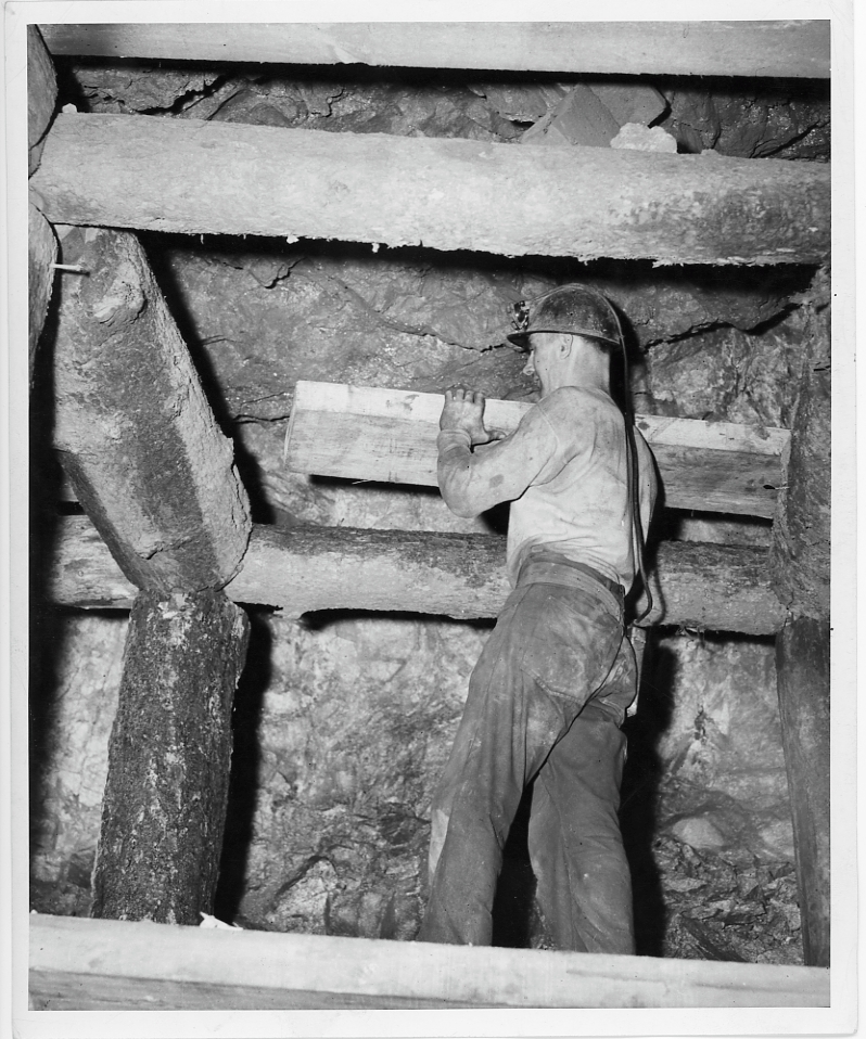 Butte miner lagging over the set after timber is blocked