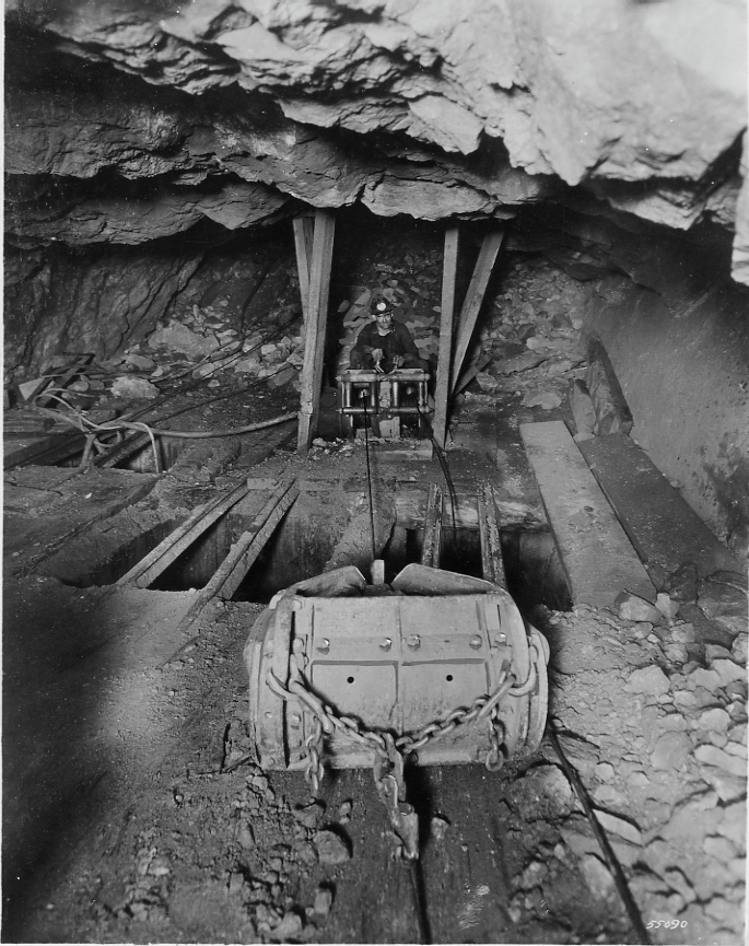 HNN-IJ double drum air hoist pulling 36" Holcomb scraper in cut and fill stope. Stope is worked both ways from central chute