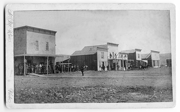 Group of Men Standing in Front Buildings, Unknown Location