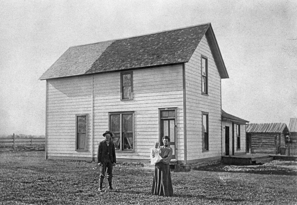 Edson, Mabel and Baby Verne Ballantyne in front of their Ranch House, Bozeman, Montana