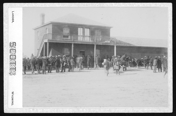 Crowd of Men Standing Outside a Building, some Sioux, Unknown Location