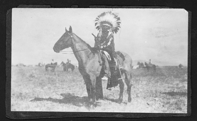 Unidentified Native American with Headdress on Horse, Unknown Location