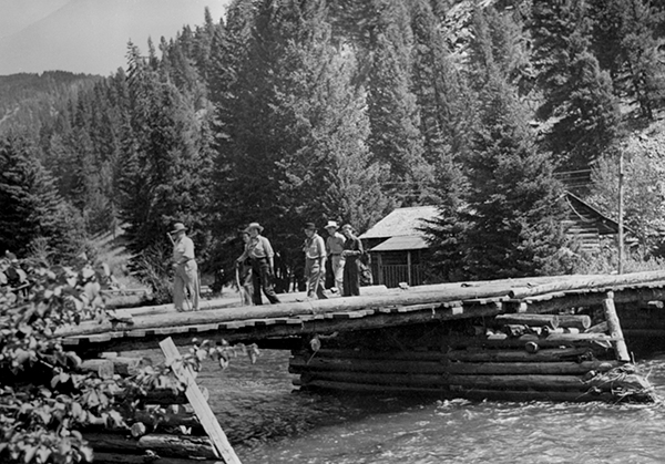 People Walking on the Old Bridge at Karst Kamp and Stage Stop, Gallatin Canyon, Montana