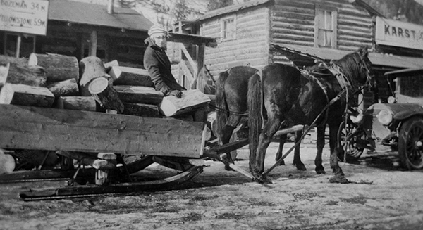 Woman on Sled Piled With Wood, Gallatin Canyon, Montana