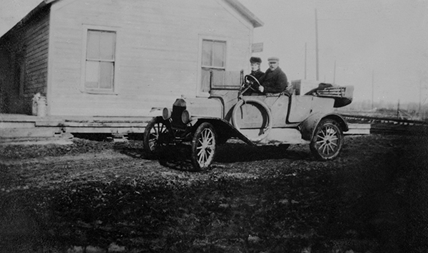 Man and Woman Riding in an Automobile at the Salesville Depot, Salesville, Montana