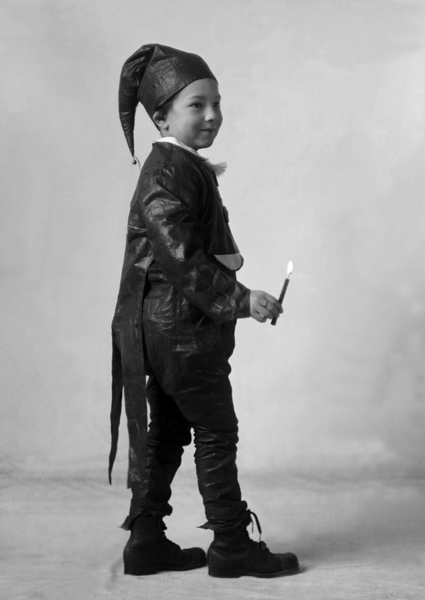 Alfred Chris Schlechten, Jr., in Costume Holding Candle, Bozeman, Montana