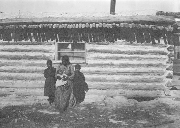 Flathead Indian Woman Holding Baby, Two Children Standing Next to Her, Unknown Location
