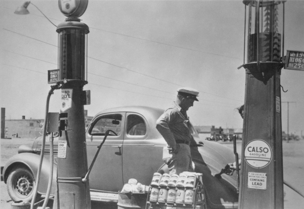 Man Filling An Automobile at a Gas Station