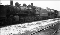 NP 15, a 2-8-0 at Staples, MN in what appears to be ready for scrap line since rods, headlight, and other front end parts are missing.