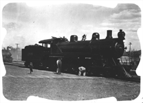 NP 288, Shown near yard office, with someone checking running gear and 2 other rails looking on